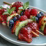 Festive Fourth of July fruit skewers with strawberries, bananas, and blueberries for patriotic celebrations.