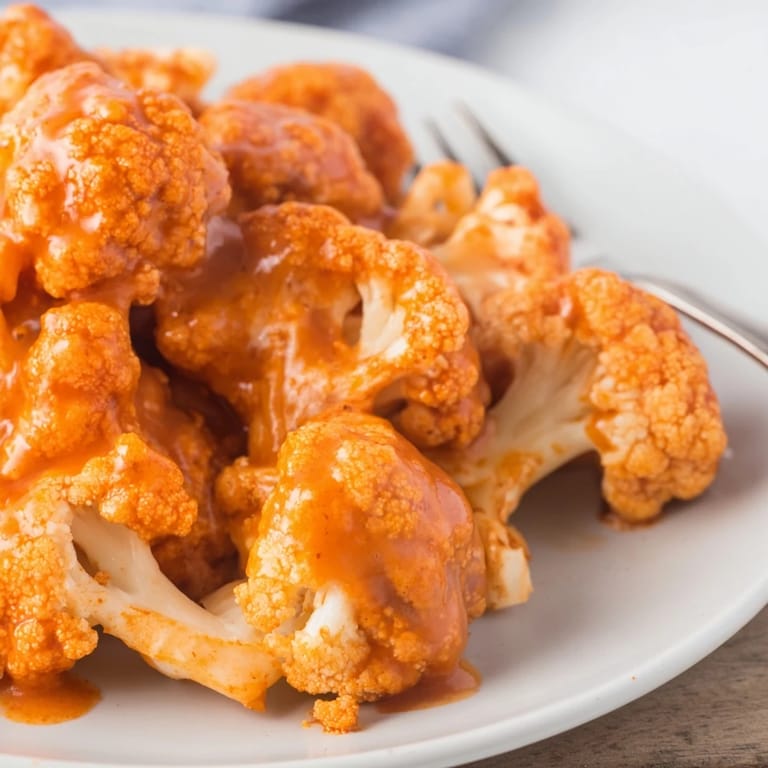 These flavorful Buffalo Cauliflower Wings are perfectly golden-brown and coated in spicy sauce.