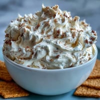 Creamy, dreamy cheesecake dip with golden graham crackers, perfect for sharing at parties or dessert spreads.